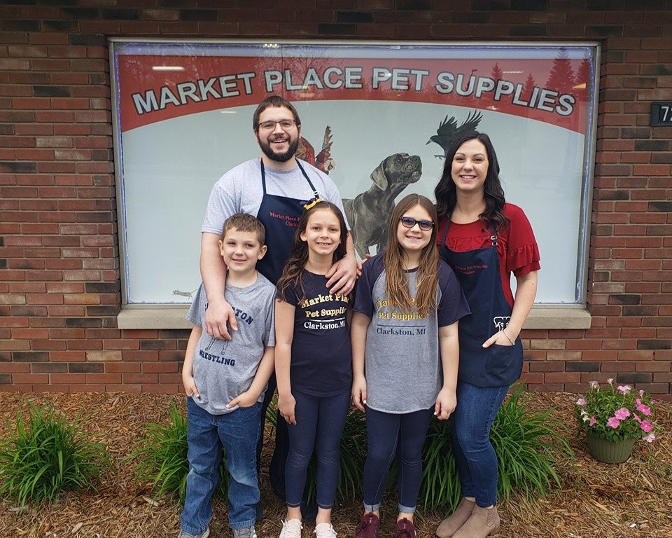 The Market Place Pet Supplies family in front of the store